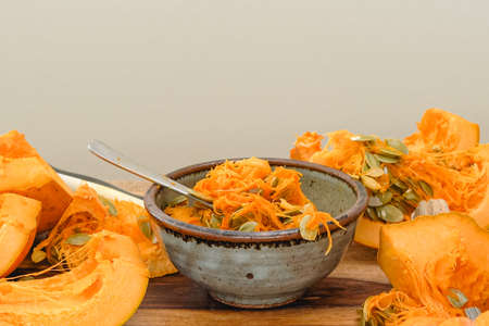 Taking out pumpkin seeds from fresh row orange pumpkin. Making pumpkin puree, step by step recipe,...