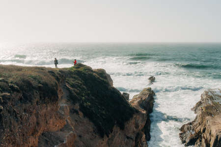 Montana de Oro, California-USA, May 8, 2021 Dramatic bluffs and ocean view, and silhouette of walking people. Montana de Oro State Park, beautiful California coastlineのeditorial素材