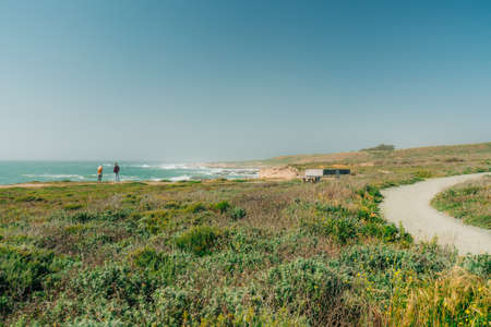Montana de Oro, California-USA, May 8, 2021 Montana de Oro State Park hiking trail with silhouette of people enjoying ocean view, clear blue sky on backrgound, copy spaceのeditorial素材