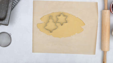 Cookie dough and cookie cutters close up on kitchen table. Shortbread cookies with raspberry jam close up baking process.の写真素材