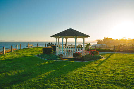 Beautiful gazebo on a seashore overlooking the ocean at sunset, Pismo Beach, Californiaの写真素材