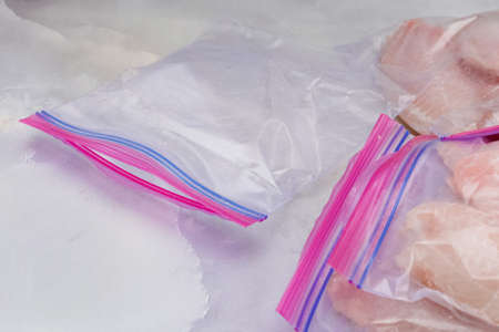 Zip lock bags close up on marble background. Using bags for freezing fresh fish filletの写真素材
