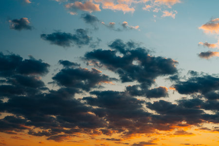 Dramatic sunset sky background with dark clouds, copy spaceの写真素材