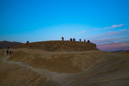Death Valley, California, USA- April 14, 2021  Zabriskie point sunset,  one of the most popular spots in Death Valley National Park to see sunset. Tourists overlooking valley.のeditorial素材