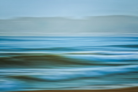 Abstract seascape background, blue hour. Cyan, blue and turquoise colors, motion blur. Pacific ocean, and mountains on background, fine art, copy spaceの写真素材
