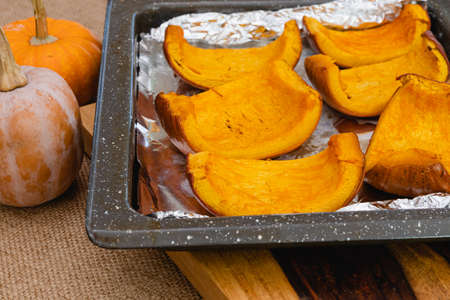 Roasted pumpkin slices close up on baking pan, homemade pumpkin puree recipeの写真素材