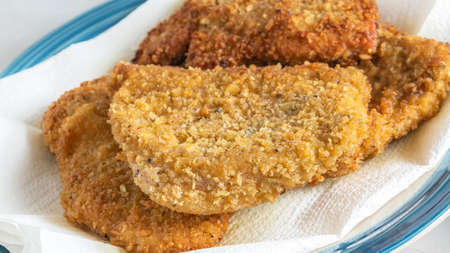 Deep fried breaded pork chops close up on plateの写真素材