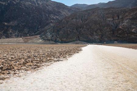 Badwater Basin hiking trail and Black Mountains in Death Valley National Park, Californiaの写真素材
