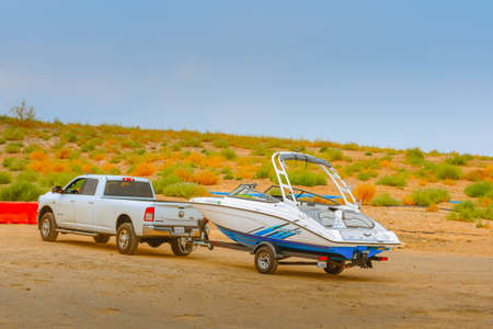 Lake Powell, Utah, USA - September 29, 2021 Car towing a boat. Lake Powell beach, parking lot