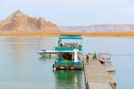 Lake Powell, Utah, USA - September 29, 2021 Houseboat on Lake Powell in Utah, long beautiful coastline on backgroundのeditorial素材