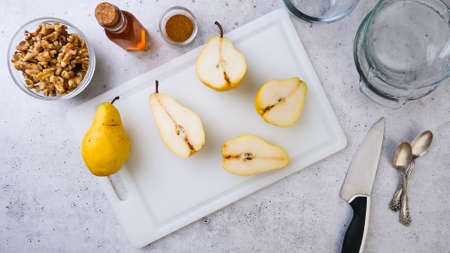 Baked pears with walnuts, honey, and cinnamon, close up on rustic background step by step recipe, perfect breakfast or dessert, flat lay, copy spaceの写真素材