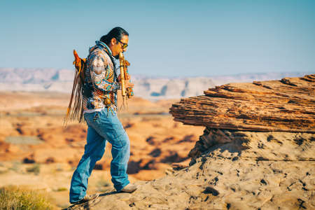 Arizona, USA- September 30, 2021   Native American flute player performing,  Glen Canyon sunrise, Arizonaのeditorial素材