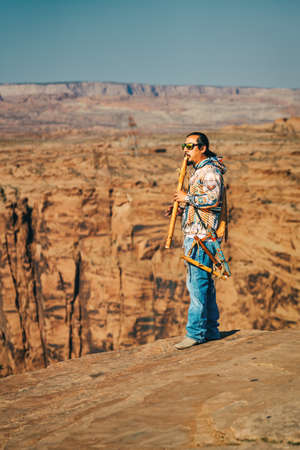 Arizona, USA- September 30, 2021   Native American flute player performing,  Glen Canyon sunrise, Arizonaのeditorial素材