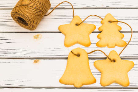 Christmas shortbread cookies close up on white wooden background, flat lay with copy spaceの写真素材