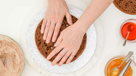 Close up baking process. Chocolate cake with cream and chocolate glaze step by step recipe. Woman...
