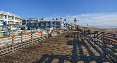 Pismo Beach, California, USA- December 15, 2021 Pismo Beach wooden pier and strip of hotels on the seafront in a sunny dayのeditorial素材