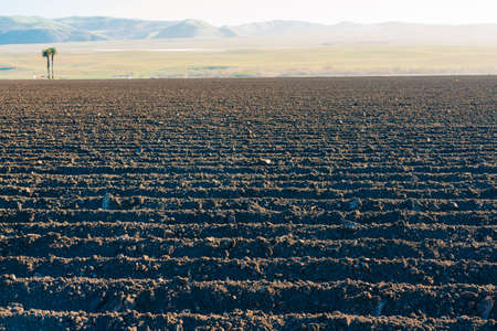 Agricultural field deeply plowed before sowing seeds, California Spring season