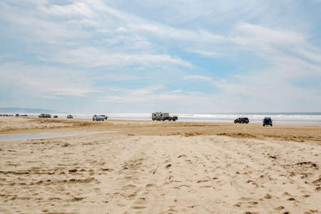 Oceano, California, USA - February 27,  2022.  Cars on the beach. Oceano Dunes, California Central Coast, the only California State Park that allows  vehicles to drive on the beachのeditorial素材
