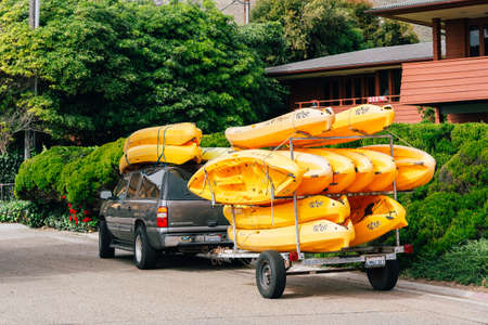 Pismo Beach, California, USA- March 26, 2022. Pismo Beach street view, kayaks towing by car on the street.Pismo Beach is a best spot along the California Central coast for diving and kayakingのeditorial素材