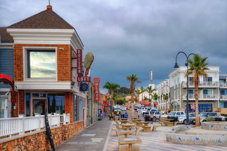 Pismo Beach, California, USA - March 3, 2022.  Pismo Beach Pier plaza at sunset. Shops, restaurants,...