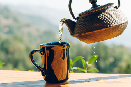 Teapot and cup outdoor on wooden background. Travel, outdoor breakfast, picnic, brunch conceptの写真素材