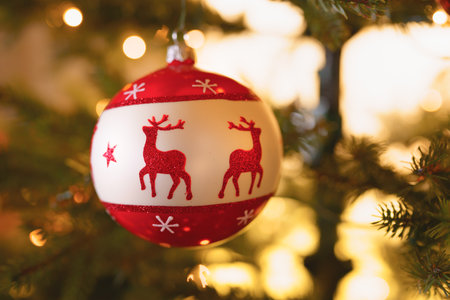 Shiny Christmas ball hanging on Christmas tree with festive background. New Year, Chrismas conceptの写真素材