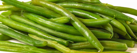 Boiled green beans close-up. French string beans, Haricots Verts, on white plate close-up