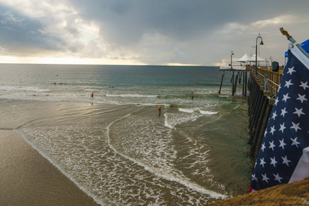 Pismo Beach, California - December 6, 2022.  Pismo beach pier during ISA World Para Surfing Championship. Long wooden pier, sandy beach, and ocean view.のeditorial素材