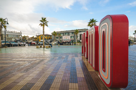 PIsmo Beach, California - December 6, 2022.  Pismo Beach Pier plaza at sunset. The large light-up letters, a new neon landmark of Pismo Beach city, Californiaのeditorial素材