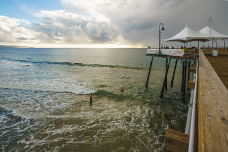 Pismo Beach, California - December 6, 2022.  Pismo beach pier during ISA World Para Surfing Championship. Long wooden pier, sandy beach, and ocean view.のeditorial素材