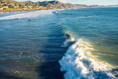 Cayucos, California, USA- December 25, 2022. Ocean surfing. Cayucos beach on California's central coast is one of the best beaches in California for surfing and swimmingのeditorial素材