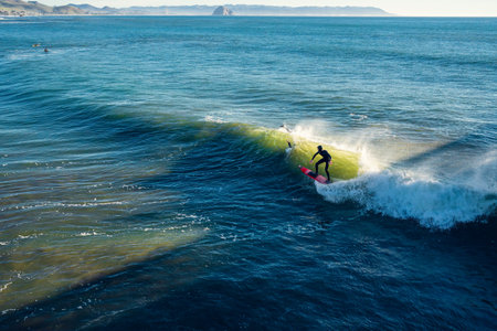 Cayucos, California, USA- December 25, 2022. Ocean surfing. Cayucos beach on California's central...