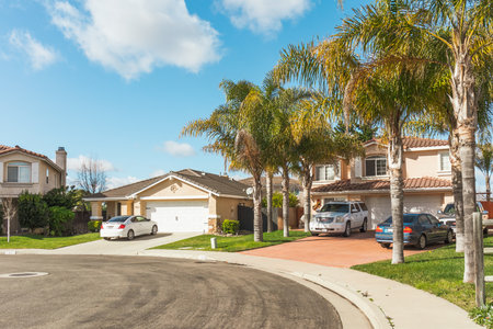 Santa Maria, California, USA - January 17, 2023. Beautiful houses with nicely landscaped front the yard, and cars parked on a sidewalk in small town in California.のeditorial素材