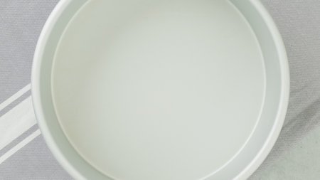 Baking pan close-up on a kitchen table, flat lay, copy space. Apple cake, or fruit cake recipe