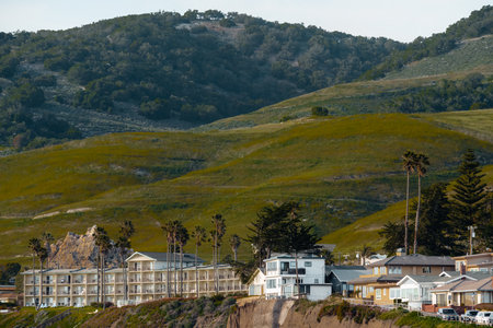 Pismo beach, California, USA-March 2, 2023.  Beachfront Pismo Beach hotels and houses on the hills. Stylish accomadations with ocean viewのeditorial素材