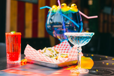 Colorful cocktail in a beautiful glass on a cafe table outdoors on a bright sunny day in  Californiaの写真素材