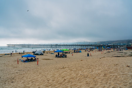 Pismo Beach, California, USA - July 2, 2023. Pismo beach, Pismo Pier, and a wide sandy beach with people enjoying the oceanのeditorial素材