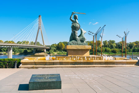 Warsaw, Poland, September 15, 2023 - Warsaw Mermaid statue, symbol of the city. View of the Vistula river and Swietokrzyski bridgeのeditorial素材