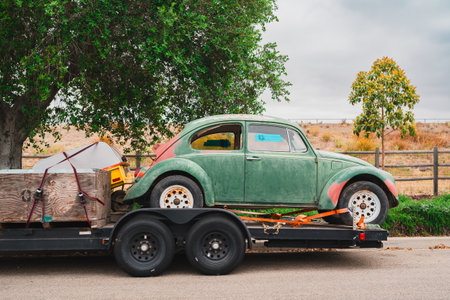 Santa Maria, California, USA - July 6, 2023.  An old vintage car on a towing track on the street