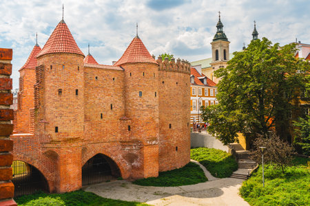 Warsaw, Poland - July 16, 2023. Old Town Warsaw. Towers and red brick walls of the historical Warsaw Barbican fort, Polandのeditorial素材