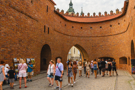 Warsaw, Poland - July 16, 2023. Old Town Warsaw. Towers and red brick walls of the historical Warsaw Barbican fort, Polandのeditorial素材