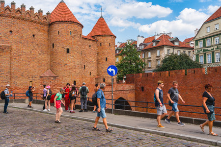 Warsaw, Poland - July 16, 2023. Old Town Warsaw. Towers and red brick walls of the historical Warsaw Barbican fort, Polandのeditorial素材