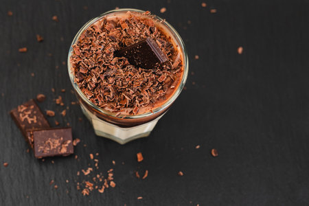 Vanilla pudding with dark chocolate topping. Perfect delicious dessert close-up in a glass on  serving boardの写真素材