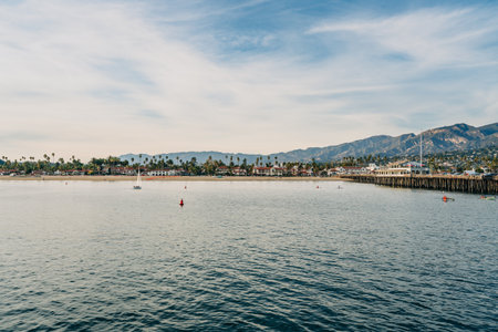 Santa Barbara harbor sunset. Quiet water, mountains, and a beautiful sunset sky in the backgroundの写真素材