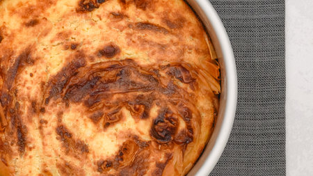 Close-up view of freshly baked phyllo dough pie with cream cheese filling, flat lay with a copy spaceの写真素材