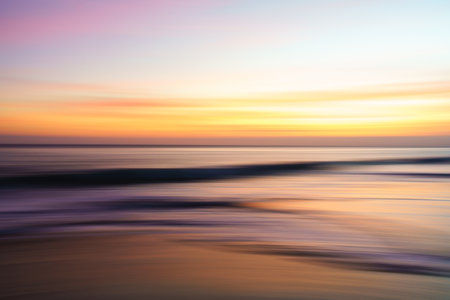 Abstract seascape, sunset on the beach, colorful scene in bright golden and purple colors, soft blurの写真素材
