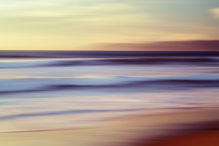 Pink sunset. Abstract seascape with blur panning motion. Sunrise or sunset over sea, beautiful soft light red and pink colorsの写真素材