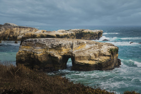 A dramatic beauty of a coastal landscape, with rugged cliffs, and crashing waves. Montana de Oro, California Central Coastの写真素材