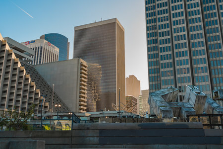 San Francisco, California, April 8, 2024. Diverse textures of urban design, with high-rise buildings and a modern art sculpture under the glow of a setting sun.のeditorial素材