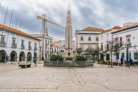 Tavira, Portugal, January 8, 2024. Town square in Tavira, Portugal, with a prominent monument and intricate cobblestone patterns, surrounded by white buildings.のeditorial素材